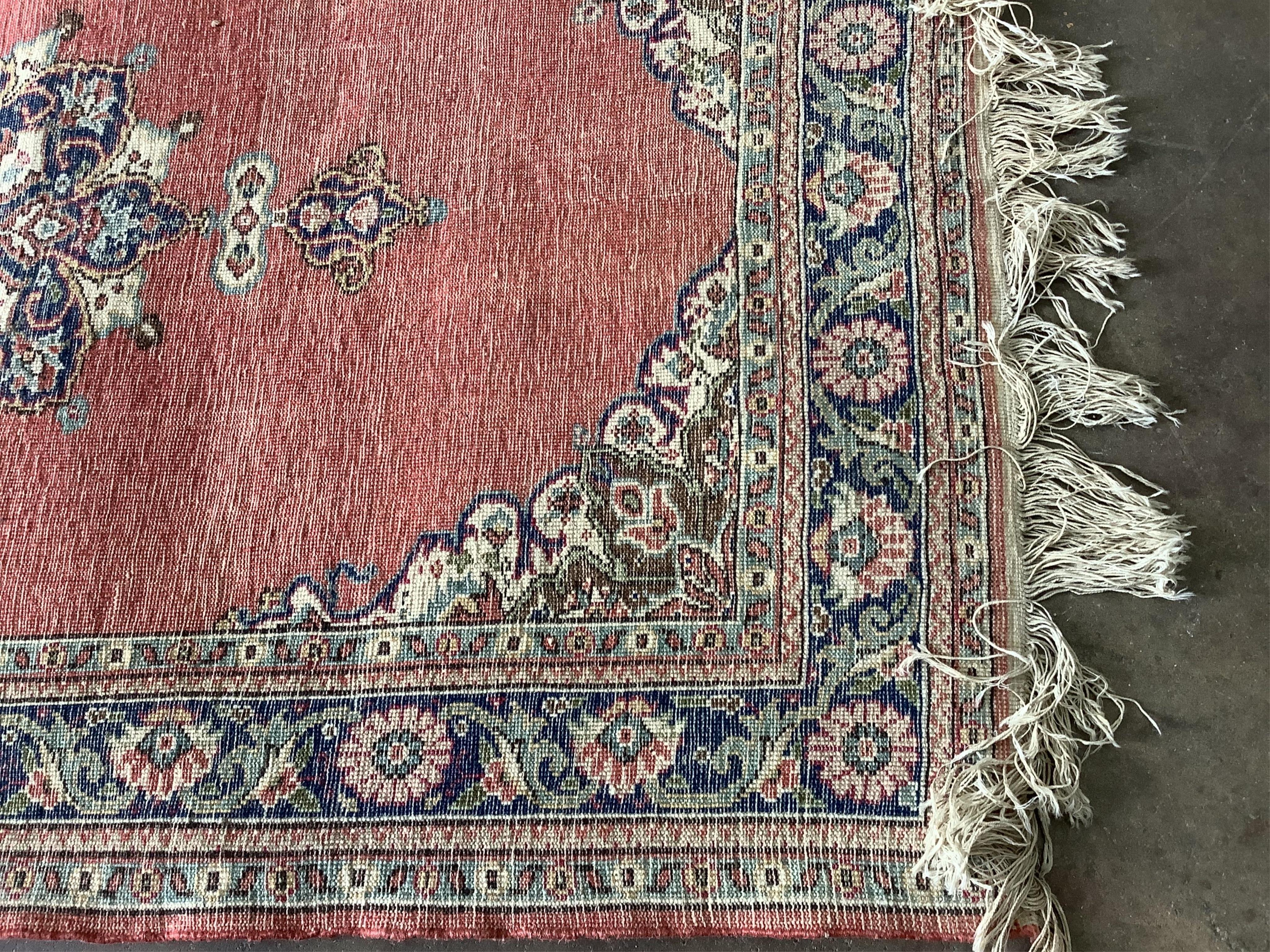 A Turkish ivory ground rug and a similar smaller red ground rug, larger 194 x 141cm. Condition - fair